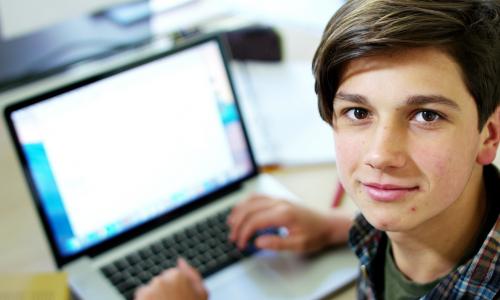 student with a laptop in the classroom