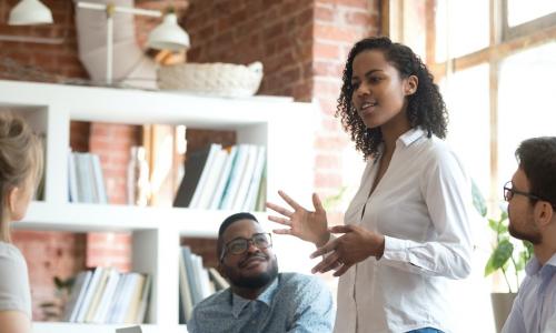 young Black businesswoman leading discussion with team