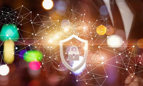 businessman in a suit behind a network of connected data points and an icon of a padlock inside a shield representing cybersecurity