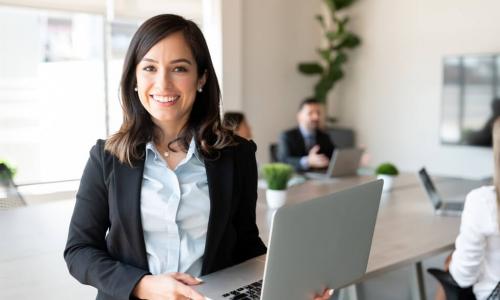 female executive with laptop in boardroom