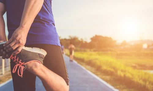 a runner stretching to warm up