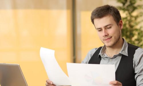 businessman thinking about and comparing two documents