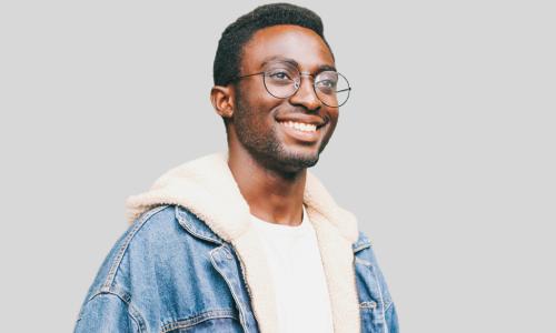 happy black gen z in jeans jacket and glasses