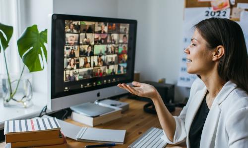 female leader managing employee talent remotely by video conference