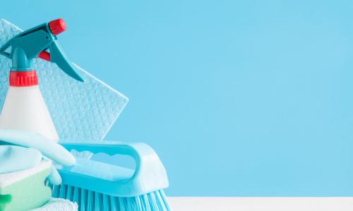 brightly colored cleaning supplies on a green background