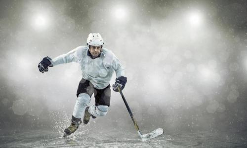 hockey player skates to the puck