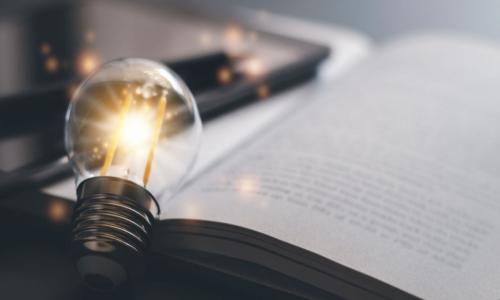 bright light bulb on a book