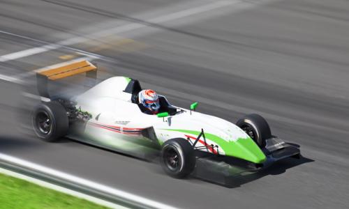 green and white formula race car racing