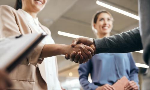 manager shaking hands and greeting new hires at the office