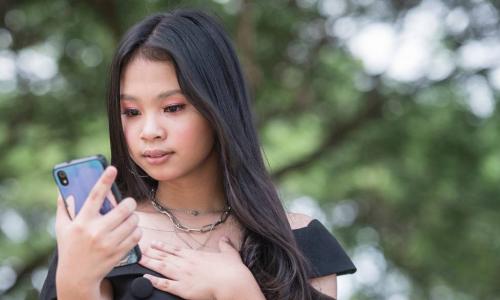 anxious Gen Z woman with smartphone