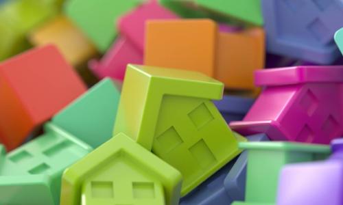 colorful plastic houses mortgage market concept