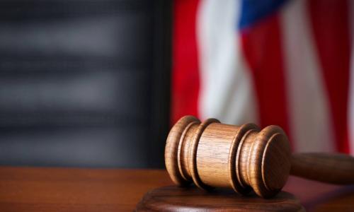 gavel on a court desk with flag