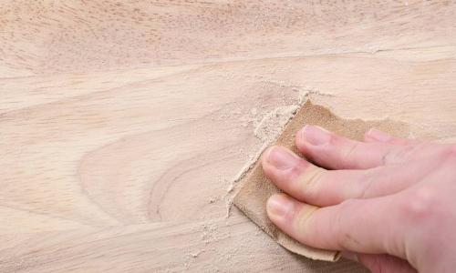 hand working with sand paper