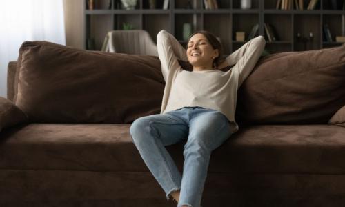 woman reclines on comfortable couch