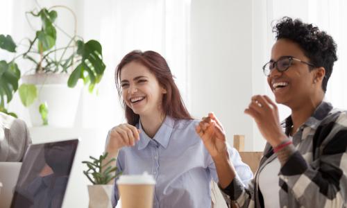 young-employees-laughing-coffee-table