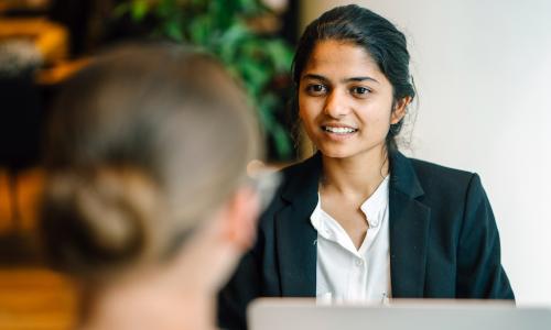 young female manager discusses performance review with female employee