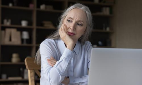 mature woman at desk with laptop