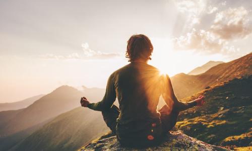 man meditate mountain sunset