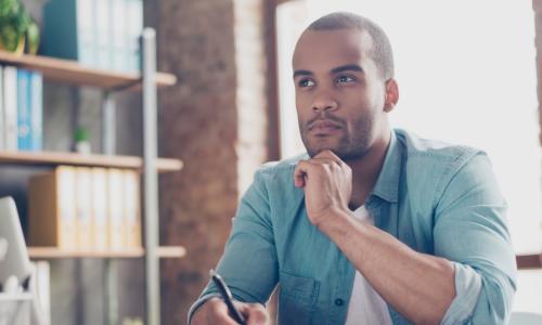 young business leader thinks about decision in work office