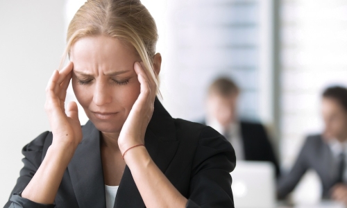 stressed young female business leader in the workplace