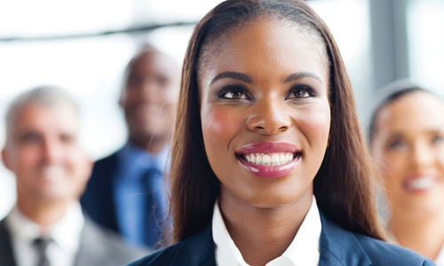 new board member smiling and standing in front of other directors