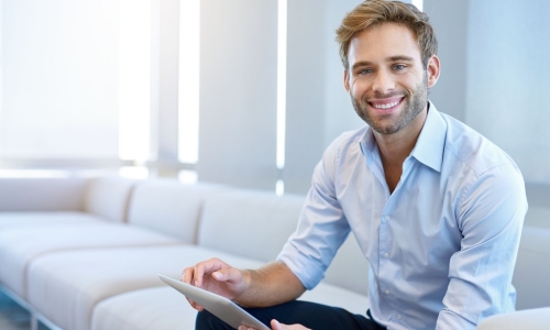 executive with ipad on couch