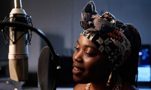 African American woman singing studio mic