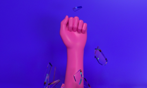 pink hand breaks through blue glass