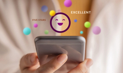 person using smartphone projecting happy face and positive reactions
