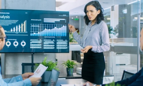 confident businesswoman gives presentation to executive team