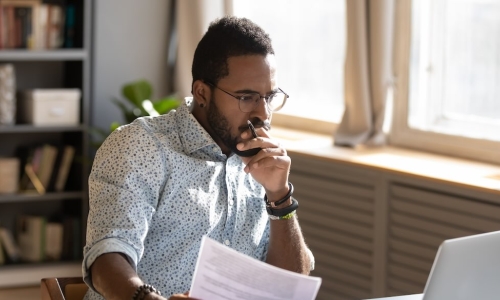 thoughtful manager working with laptop