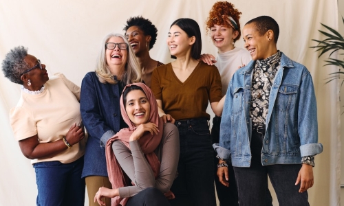 group of professional women take team photo together