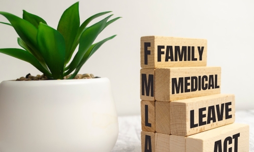 FMLA wooden blocks that read Family medical Leave Act