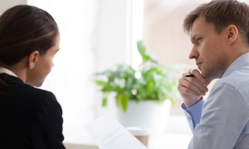 manager having tough conversation with employee at the office