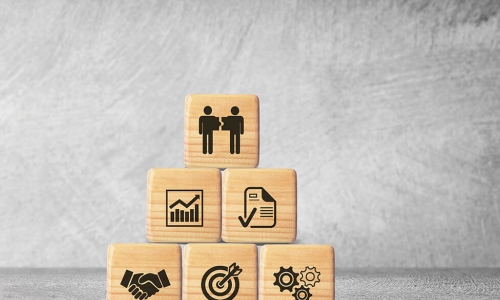 wooden blocks with pictures representing employees and organizational culture