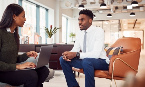 manager and employee having one-on-one meeting at the office