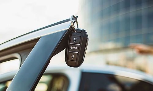 car keys hanging from corner of open car doors