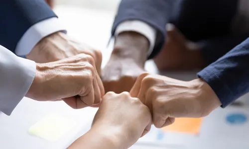 5 fists coming together to form a circle