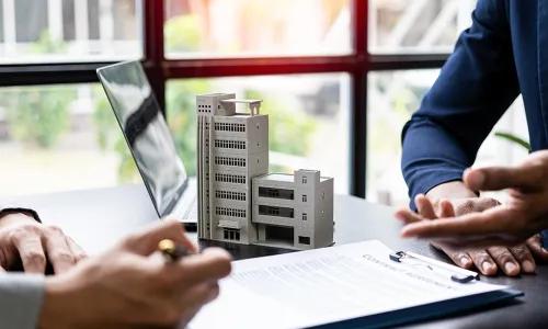 document on desktop while individuals talk over it