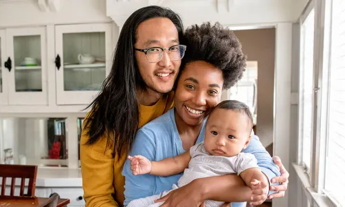 Family of 3 posing in dining room