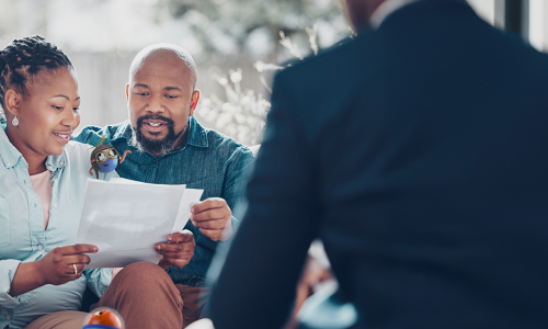 couple smiling looking over documents