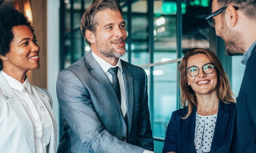 group of people with 2 gentlemen shaking hands