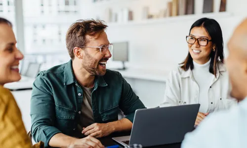 coworkers laughing while working together