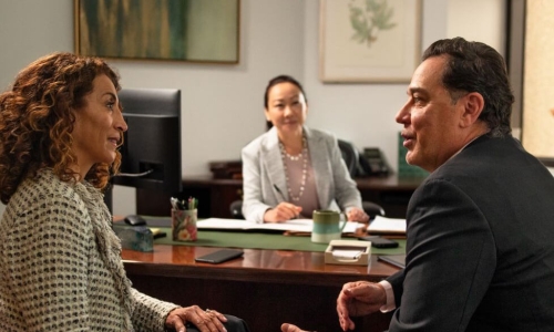 couple sitting at desk talking