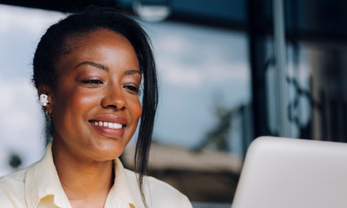 woman smiling at computer screen