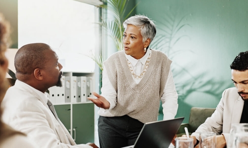 woman explaining to a man over a laptop